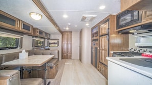 Prepare meals in the well-equipped kitchen with a central island, microwave, stove, and ample storage.
