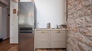 Fridge, stovetop, cookware/dishes/utensils, dining tables