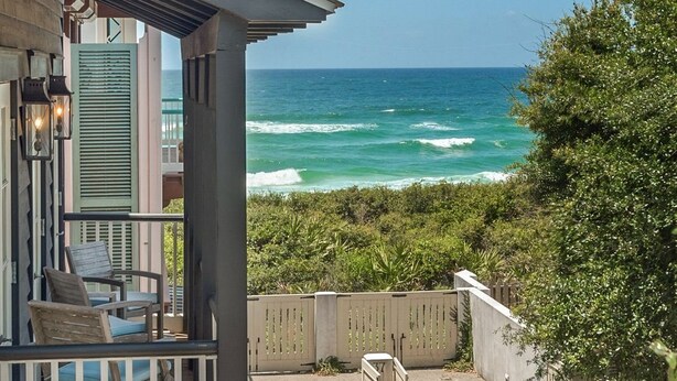 A coastal property with a balcony overlooking the ocean, featuring a wooden deck and outdoor seating. - PRIVATE BEACH/POOL ACCESS-Ultimate Getaway-Gulf Views-Steps to Beach-2 Bikes (Rosemary Beach)