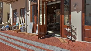 A building entrance with a wooden door, a number '38' above the door, and a brick-paved area with steps leading up to the entrance. - PRIVATE BEACH/POOL ACCESS-Ultimate Getaway-Gulf Views-Steps to Beach-2 Bikes (Rosemary Beach)