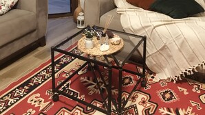 A living room with a sofa, a coffee table, and a patterned rug. - Iberia Villas (Ortaca)