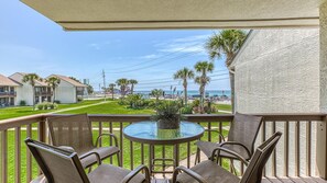 Enjoy a tranquil ocean view from this balcony, featuring a table and chairs.