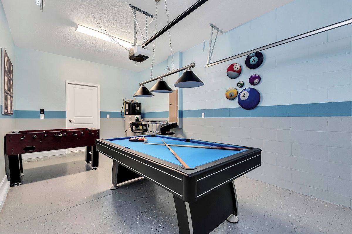 Fun Game Room of the Home in Davenport Florida - Sleek pool table for thrilling matches - Classic foosball table for fast-paced fun - Vibrant space where competition and camaraderie thrive