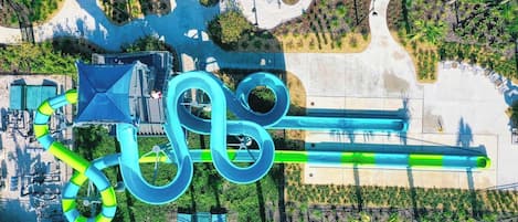 An aerial view of a water park with multiple slides and pools.