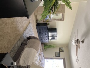 Cozy living space with a sofa, table, and flat-screen TV.