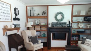 A living room with a fireplace, a sofa, a chair, and a coffee table.