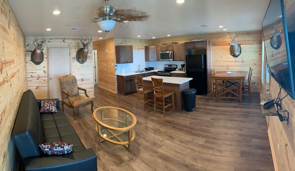 A cozy cabin interior with a living area, kitchen, and dining space. - Spacious 3-Bedroom 2-Bath Houseboat in Venice for Rent (Venice)