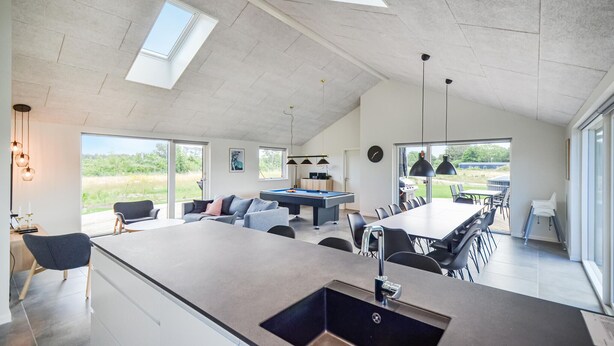 A spacious living area with a pool table, a dining table, and a kitchen area. - Luxurious home in Glesborg with WiFi (Glesborg)