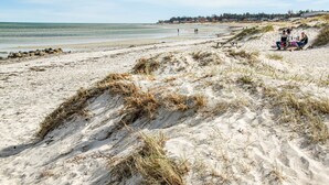 A sandy beach with dunes and a distant shoreline. - Luxurious home in Glesborg with WiFi (Glesborg)