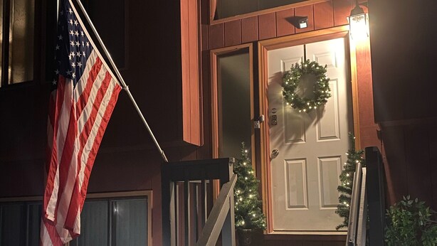 A wooden front porch with a bench, a small Christmas tree, and an American flag. - Beautiful Bi-level. Game room with pool table, 5 UHDTVs, WiFi. Central heat/air. (Bushkill)