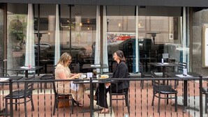 An outdoor seating area with tables and chairs at a restaurant named 'the Block Bistro & Grill.' - EXECUTIVE STAY+KING BED+WIFI+W/D+PETS (Indianapolis)