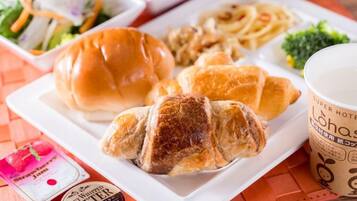 A meal with a sandwich, croissant, pasta, and a cup of coffee on a white plate.