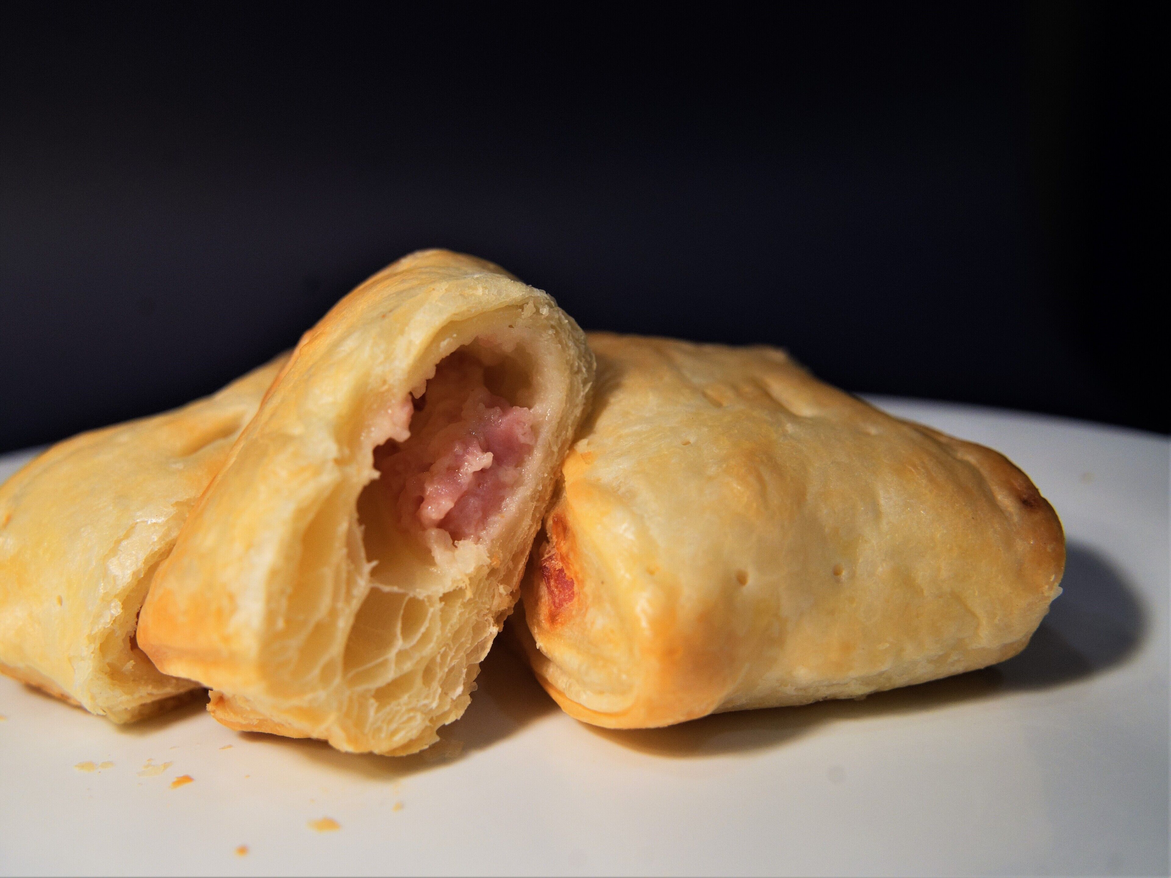 A pastry with a flaky crust and a visible filling.
