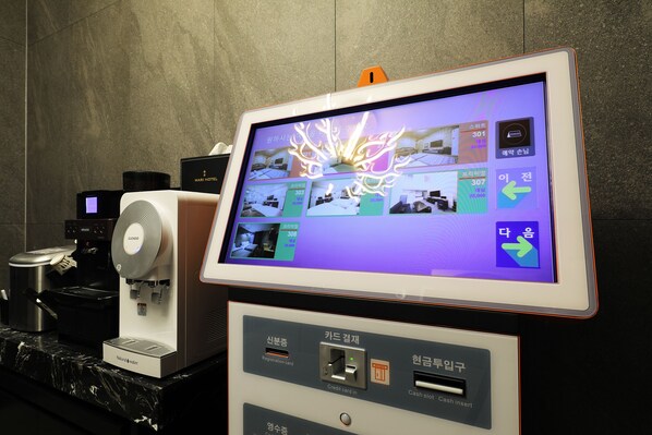 A coffee machine with a digital display and a cash slot.