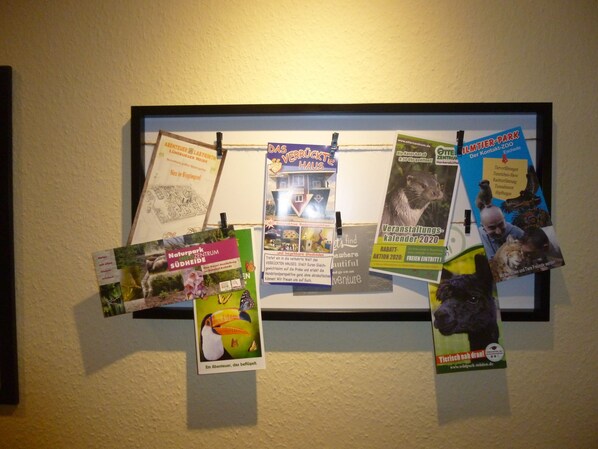 A bulletin board with various printed materials pinned to it.