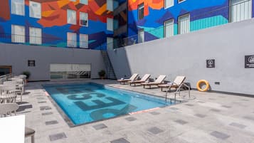 Outdoor pool, open 7:00 AM to 7:00 PM, pool umbrellas