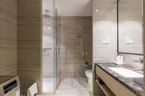 A modern bathroom with a glass-enclosed shower, a marble sink, and a large mirror. - Huafa Exhibition Executive Aparthotel (Zhuhai)