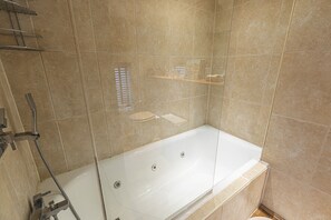 Comfort Room (1 Bedroom) | Bathroom | Bathtub, hair dryer, towels, soap