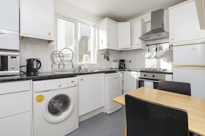 Comfort Room (1 Bedroom) | Private kitchen | Oven, coffee/tea maker, electric kettle, dining tables