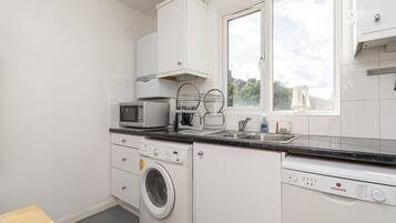 Comfort Room (1 Bedroom) | Private kitchen | Oven, coffee/tea maker, electric kettle, dining tables