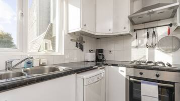 Comfort Room (1 Bedroom) | Private kitchen | Oven, coffee/tea maker, electric kettle, dining tables