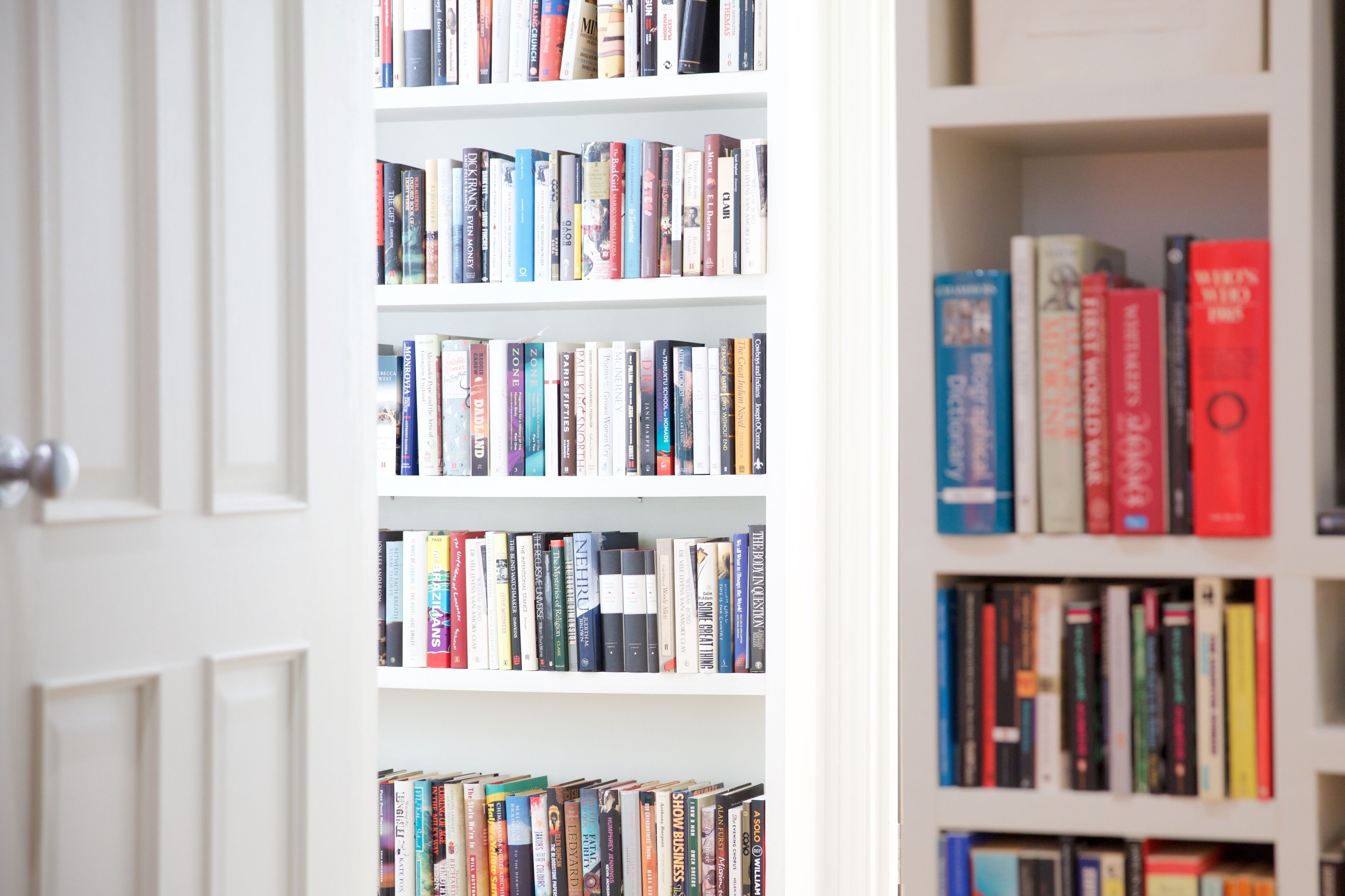 A bookshelf with various books.