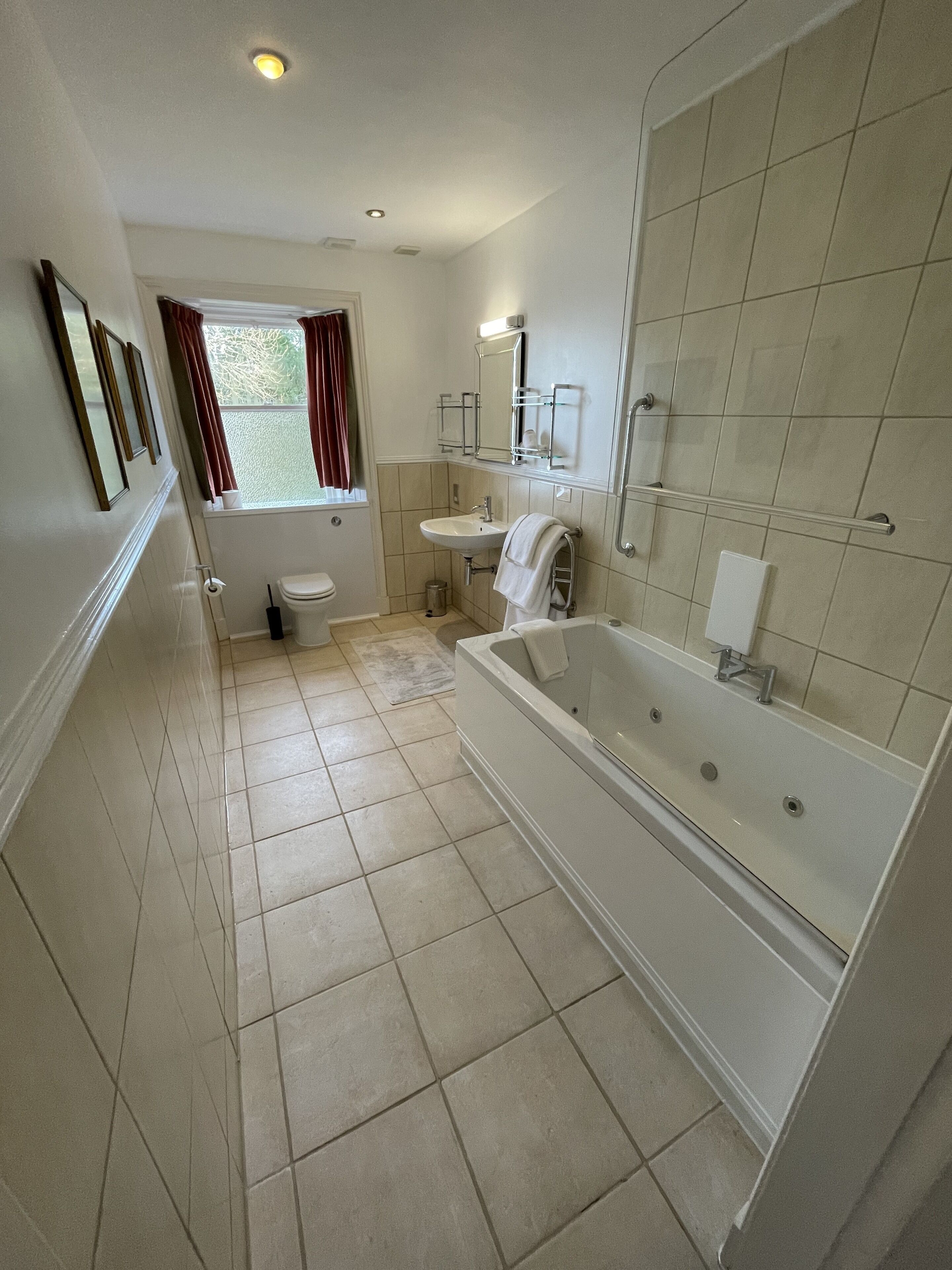A bathroom with a bathtub, sink, and toilet.