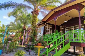 A building with a porch, green railings, and a staircase. - Together Palm Resort (Semporna)