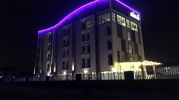 A multi-story building with a flat roof and a sign at the top. - Zleep D Hotel (Udon Thani)