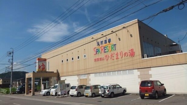 A building with a sign reading 'Sparesort' and several parked cars in front.