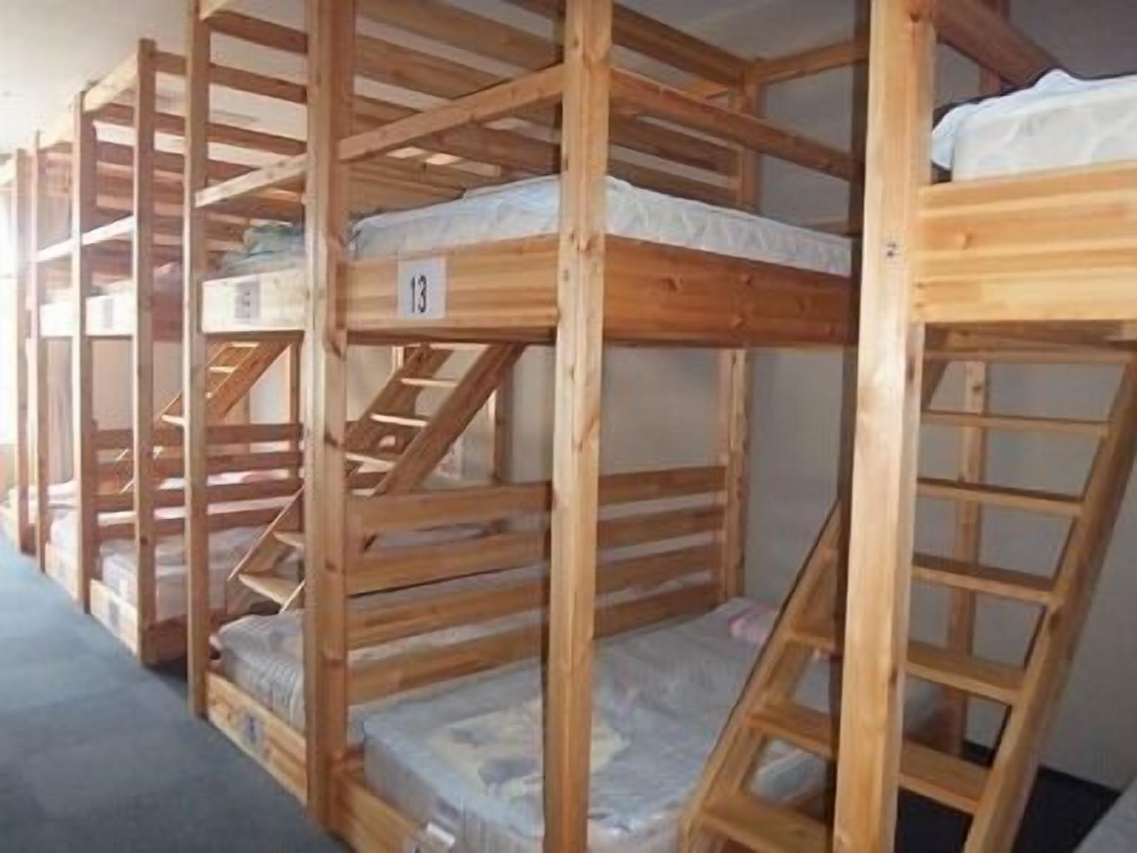Bunk beds with a ladder, a mattress, and a number sign.