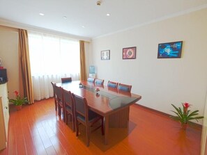 A conference room with a long table, chairs, and potted plants. - Greentree Inn Shanghai National Convention Center Xinfu Middle Road Huazhi Road Hotel (Shanghai)