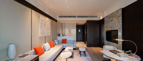 A modern living room with a sofa, coffee table, and a TV.