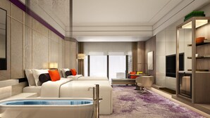 A modern hotel room with a large bed, a seating area with a coffee table, a TV, and a minibar. - Crowne Plaza Shenzhen Nanshan (Shenzhen)