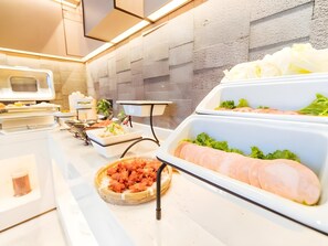 A buffet setup with various food items including sliced meats and vegetables. - GYA Langfang Art Avenue Civic Service Center Daxing International Airport Hotel (Langfang)