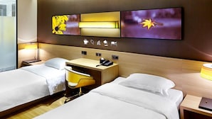 A hotel room with two beds, a desk, and a chair. There are wall-mounted controls and a flat-screen TV. - 7 Days Premium (Shenzhen)