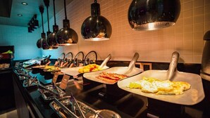 A buffet setup with various food items and utensils. - Fenk Attitude Hotel (Guangzhou)