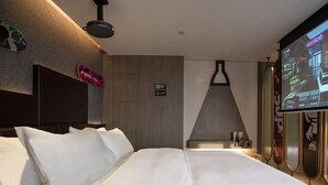 A modern hotel room with a large bed, a television mounted on the wall, and a sign indicating the room number. - Fenk Attitude Hotel (Guangzhou)