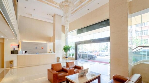 A spacious lobby with leather seating, a reception desk, and large windows offering a view of the street. - 7 Days Premium·xiamen Airport (Xiamen)