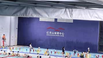A swimming pool area with lane dividers and a banner with text.