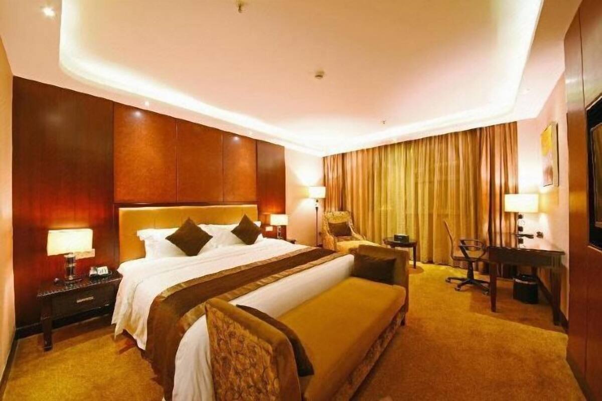 Relax in comfort with a large bed, desk, and TV.