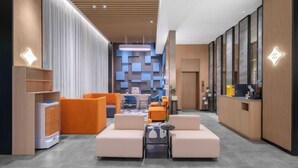 A modern hotel lobby with a central seating area, a reception desk, and a patterned wall in the background. - Jinjiang Inn (Wenzhou Railway Station) (Wenzhou)