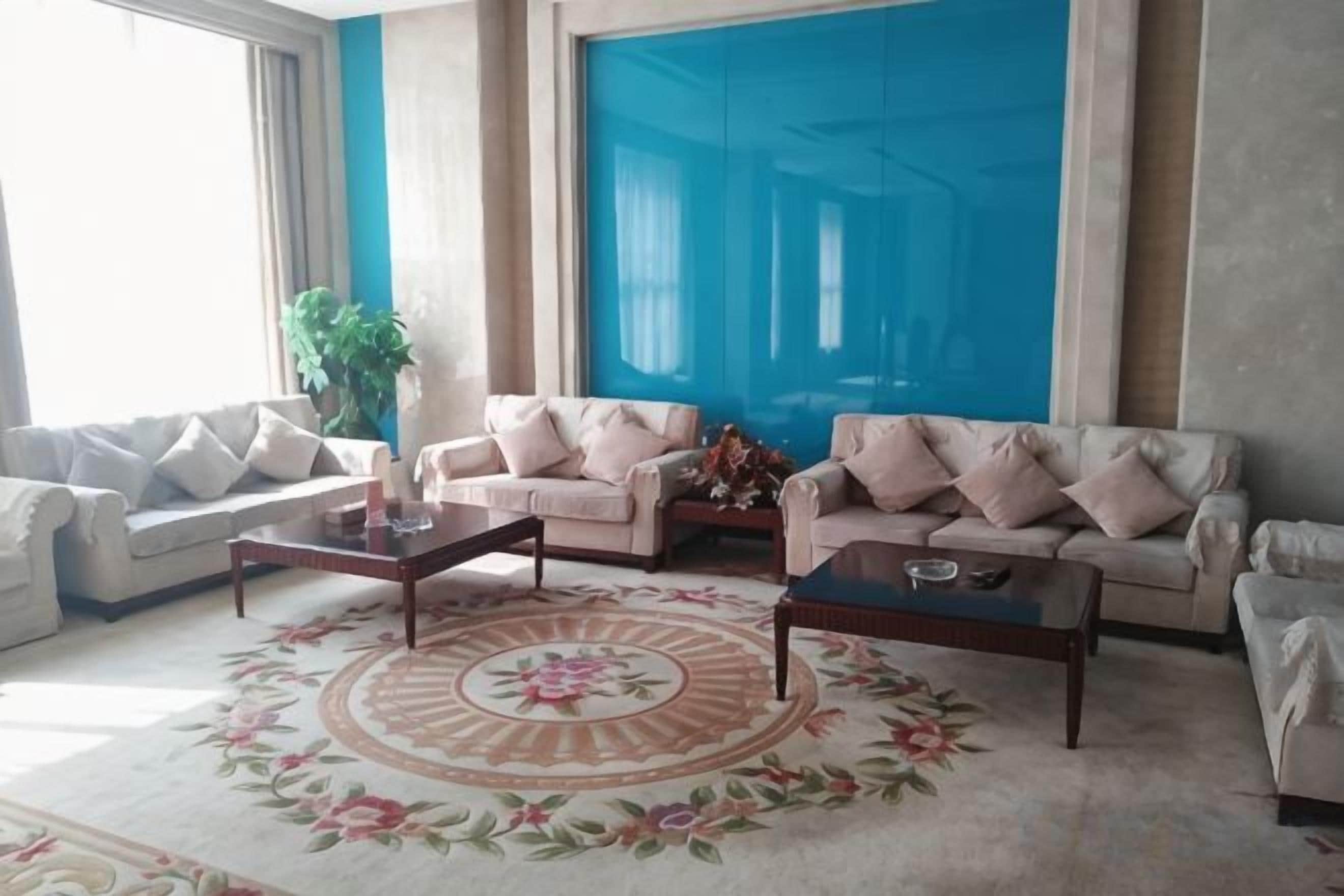 A living room with two sofas, a coffee table, and a large window.