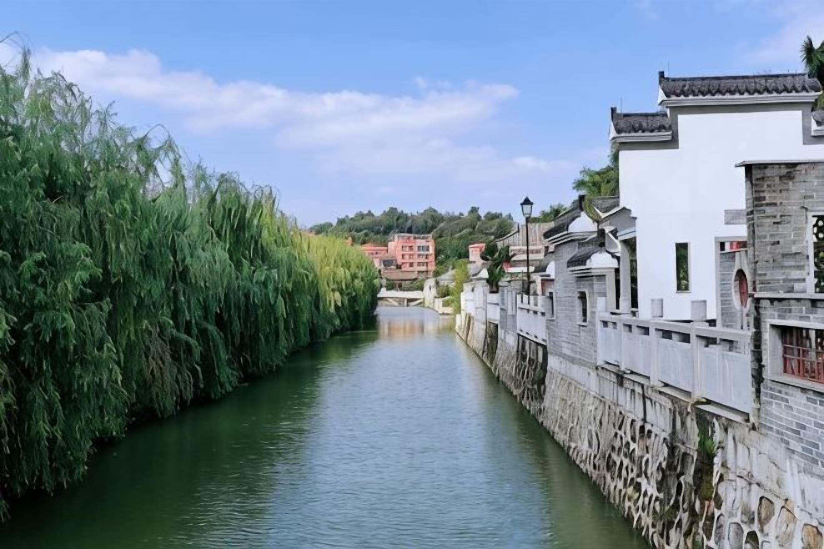 Un canal estrecho bordeado por edificios tradicionales con muros de piedra y techos de tejas.