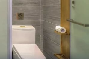 A modern bathroom with a toilet, a towel rack, and a sign on the wall. - James Joyce Coffetel Changsha Youyi Road Metro Station (Changsha)