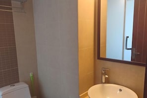 A bathroom with a toilet, a sink, and a mirror. - S One Hotel (Shanghai)