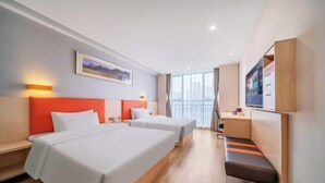 A hotel room with two beds, a desk, a bench, a TV, and a window with a city view. - 7 Days Premium (Chongqing Liangjiang New District, Yufu Industrial Park, Yuzui) (Chongqing)