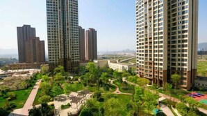 A high-rise residential building complex with multiple apartment buildings, surrounded by well-maintained greenery and pathways. - 7 Days Premium (Chongqing Liangjiang New District, Yufu Industrial Park, Yuzui) (Chongqing)