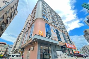 A multi-story building with a prominent entrance and signage.