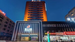 A hotel with a modern facade, illuminated signage, and a prominent entrance. - Jinjiang Inn (Anyang Railway Station) (Anyang)